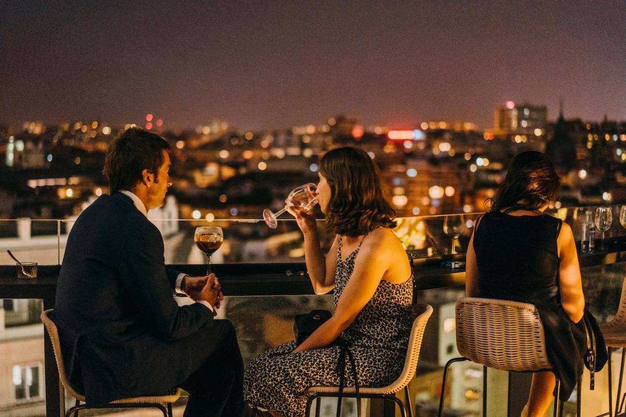 Dear Hotel Madrid Esterno foto "A couple having drinks on the rooftop of a hotel."